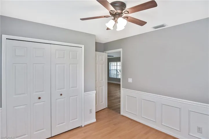 Unfurnished bedroom featuring light hardwood / wood-style floors, ceiling fan, and a closet