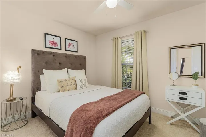 Bedroom featuring light colored carpet and ceiling fan