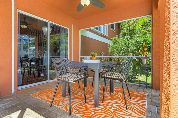 Balcony with a ceiling fan, outdoor dining area, and a sunroom