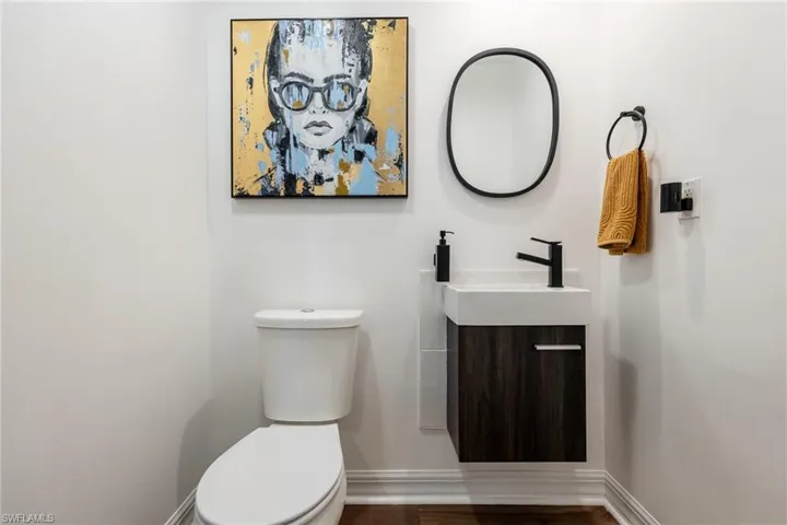 Half bath with vanity and baseboards