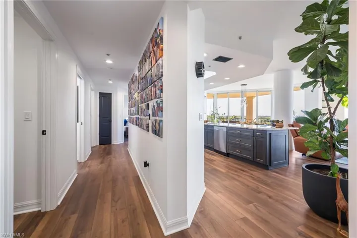 Hall featuring recessed lighting and dark wood-style flooring