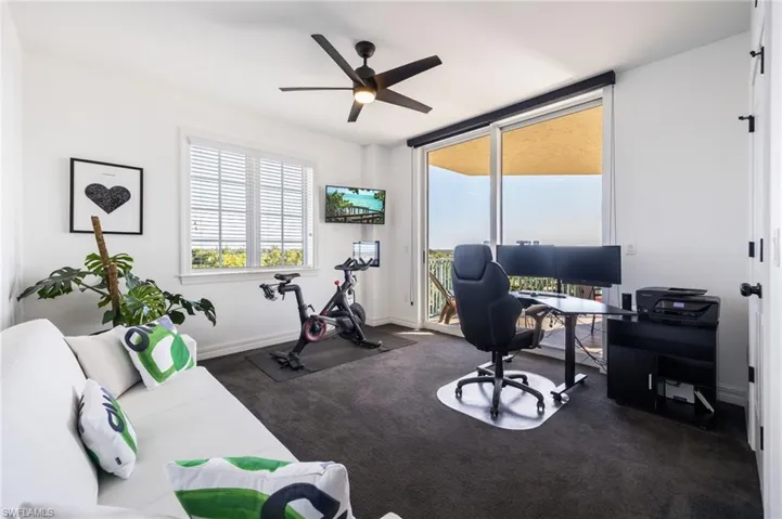 Office with plenty of natural light, ceiling fan, and dark carpet