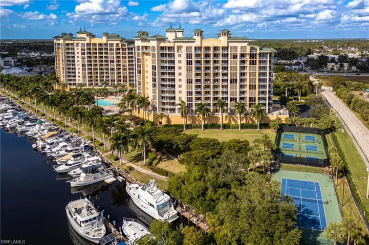 View of apartment building / complex with view of marina and a water view