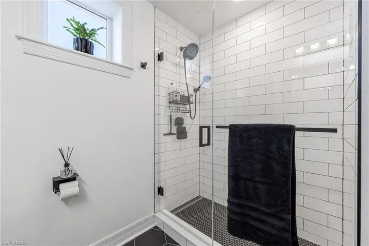 Bathroom with a stall shower and baseboards
