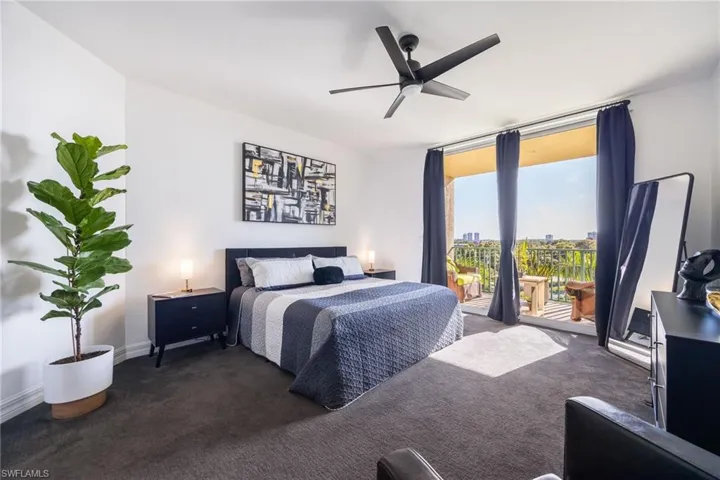 Bedroom featuring access to exterior, carpet floors, and ceiling fan