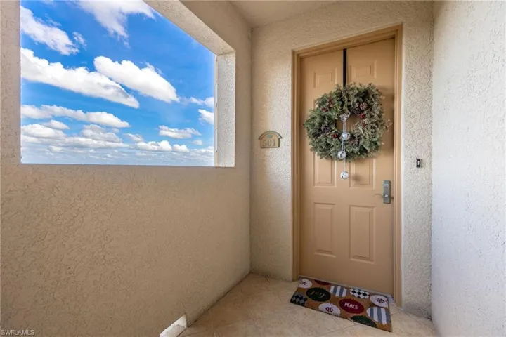 Doorway to property with stucco siding