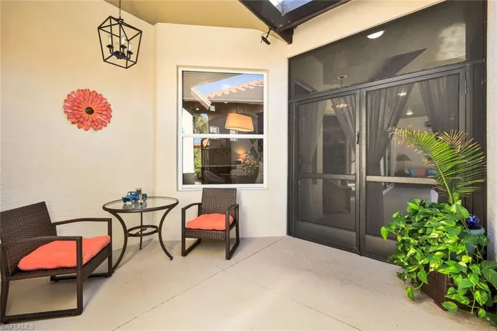 Property entrance with stucco siding and a patio