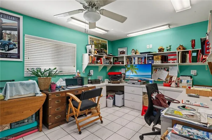Office featuring light tile patterned floors and a ceiling fan