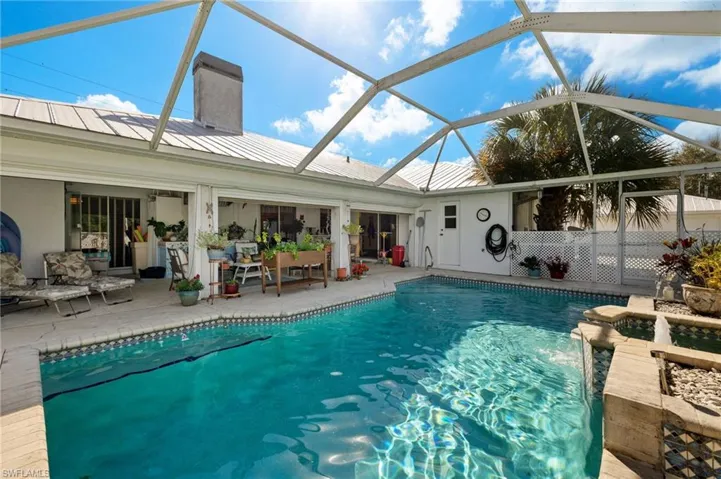 Outdoor pool with glass enclosure and a patio