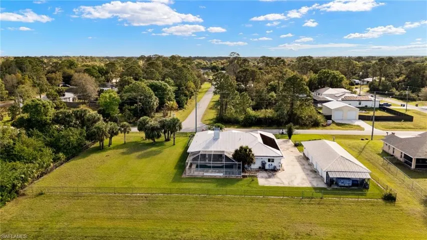 Birds eye view of property with a wooded view