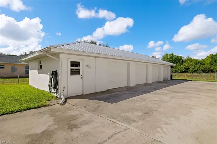 Detached garage featuring fence
