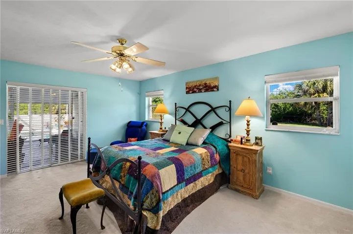 Bedroom featuring carpet, baseboards, and a ceiling fan