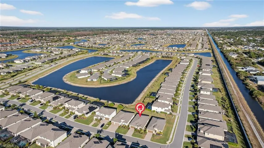 Aerial view of property's location featuring nearby suburban area and a large body of water