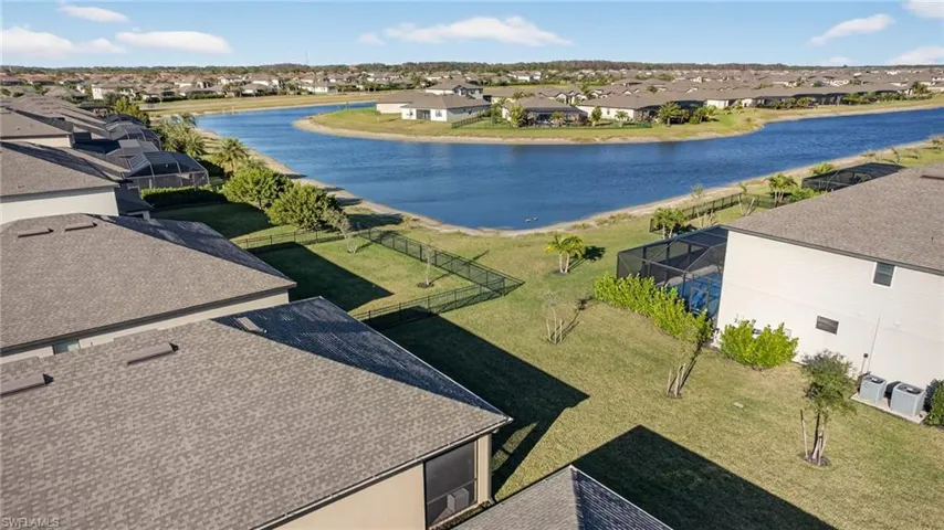 Aerial perspective of suburban area featuring a large body of water