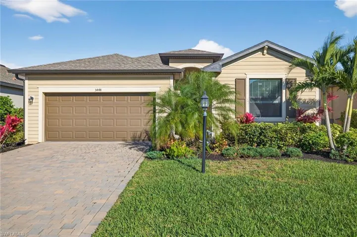 View of front of property with driveway, a garage, and a front yard