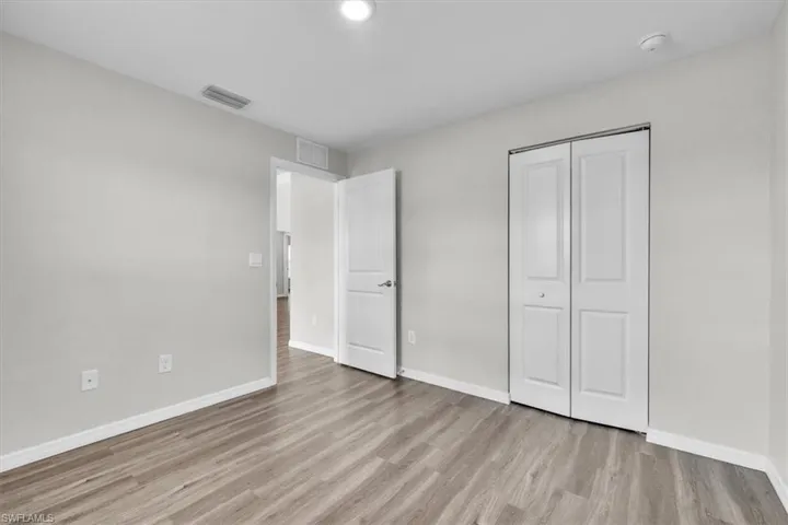 Unfurnished bedroom with light wood-style flooring and a closet