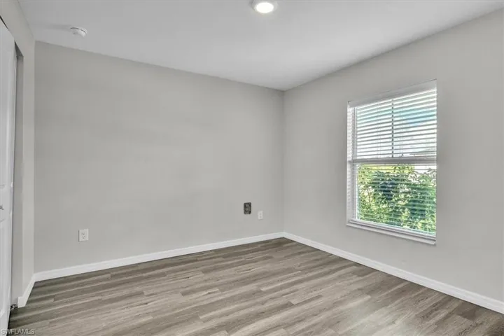 Empty room with light wood-type flooring and recessed lighting