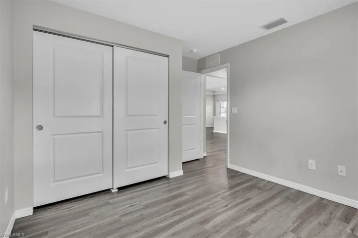 Unfurnished bedroom with light wood finished floors and a closet