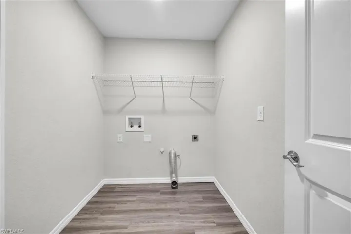 Washroom with gas dryer hookup, light wood-type flooring, hookup for a washing machine, and electric dryer hookup