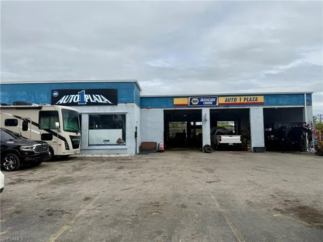 View of commercial property featuring uncovered parking