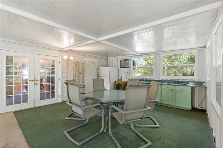 Sunroom featuring french doors and a wall unit AC