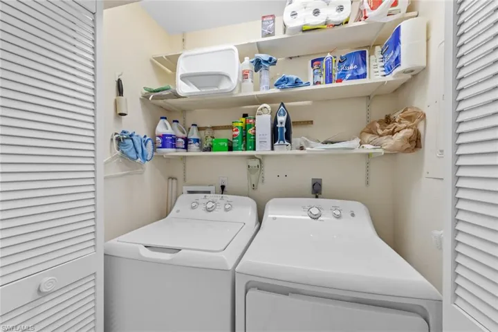 Washroom with washing machine and clothes dryer