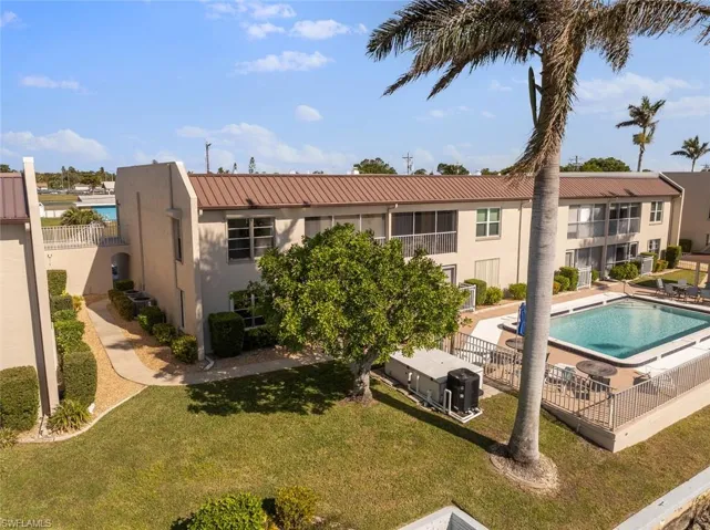 View of pool with a lawn