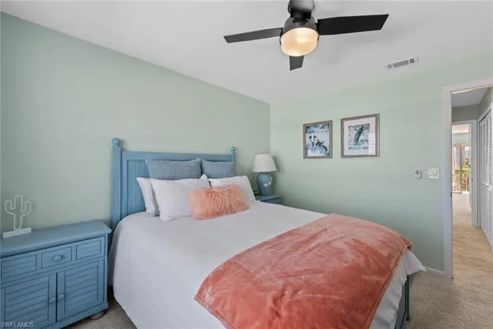 Bedroom featuring light colored carpet and ceiling fan