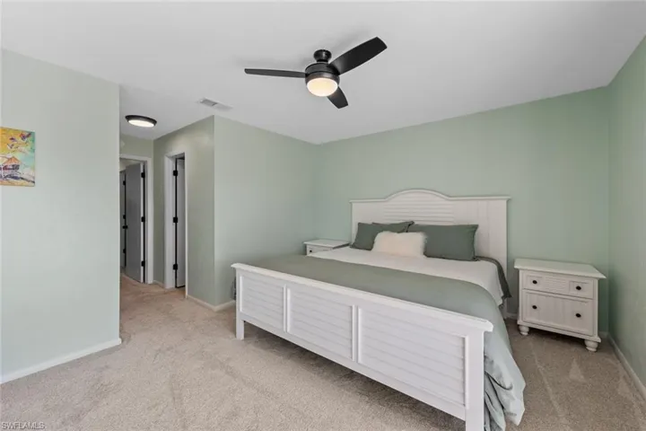 Bedroom featuring ceiling fan and light colored carpet