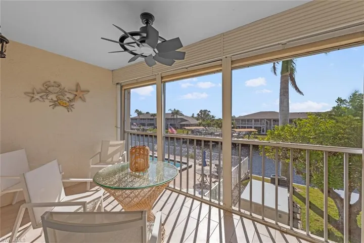 Sunroom featuring a water view and ceiling fan