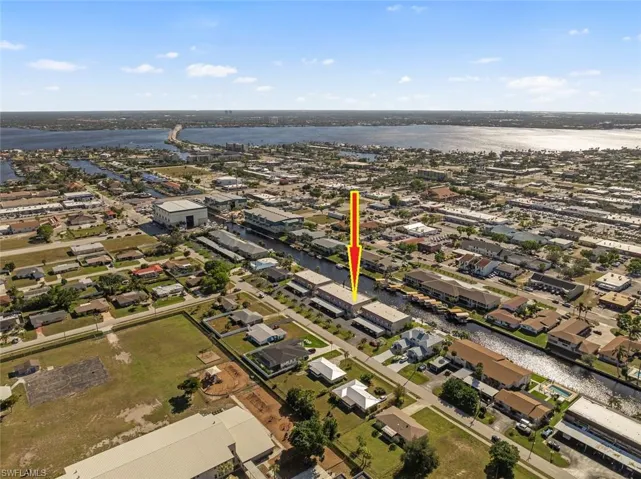 Birds eye view of property with a water view