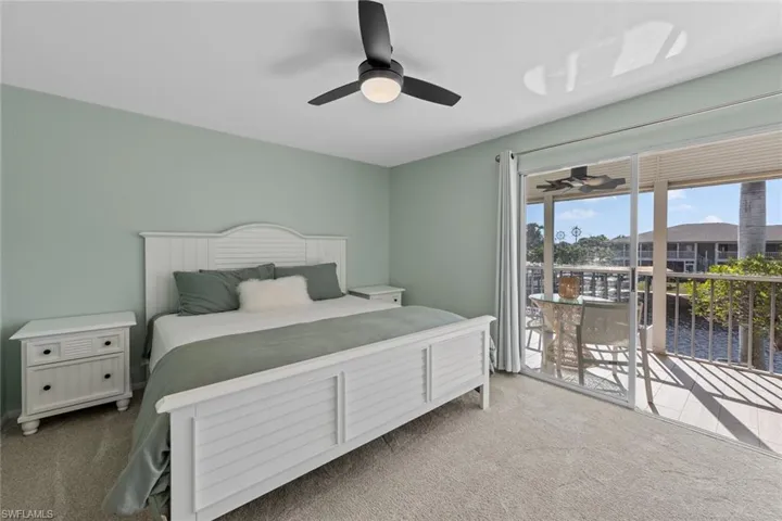Carpeted bedroom with ceiling fan