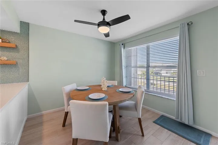 Dining area with light hardwood / wood-style floors and ceiling fan