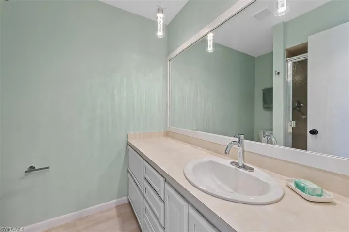 Bathroom featuring vanity and a shower with shower door