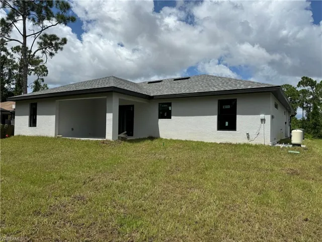 Back of house featuring a lawn