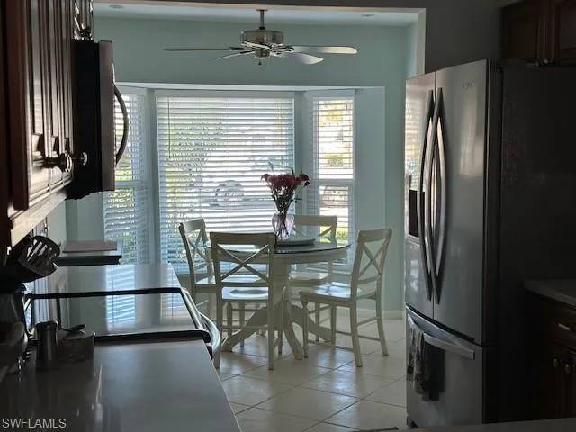 Dining space with light tile patterned flooring and ceiling fan