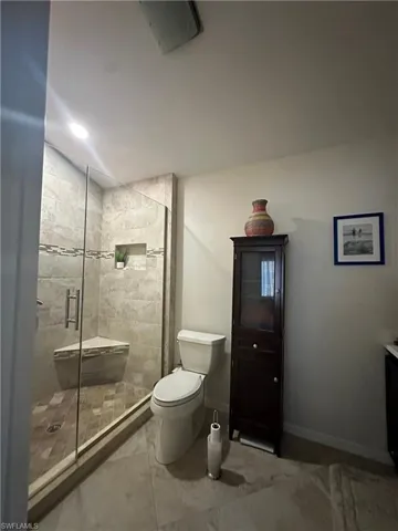 Full bath with vanity, a shower stall, recessed lighting, and tile patterned floors