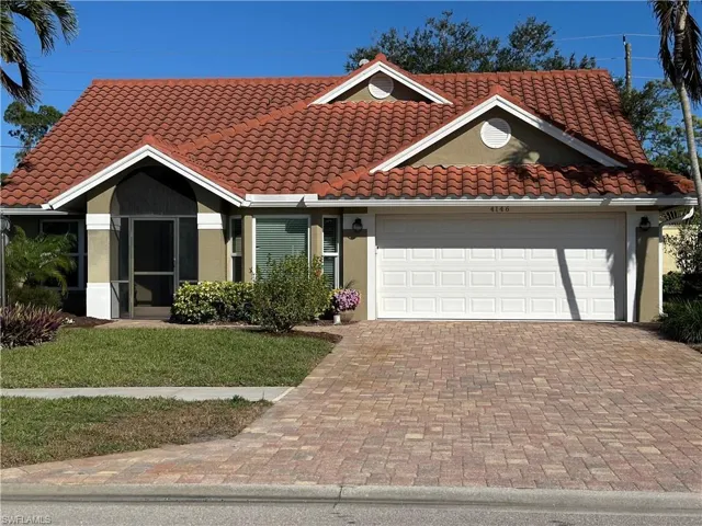 Mediterranean / spanish home with decorative driveway, stucco siding, a garage, a front yard, and a tile roof