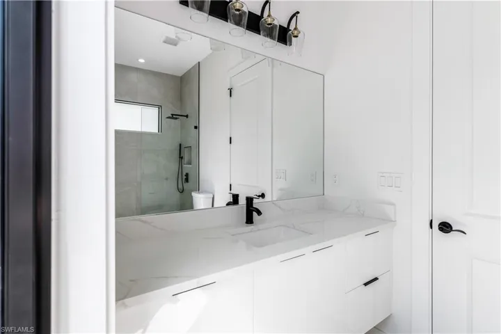 Full bathroom featuring vanity and a tile shower