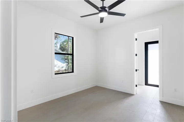 Bedroom featuring ceiling fan and wood-like tile.
