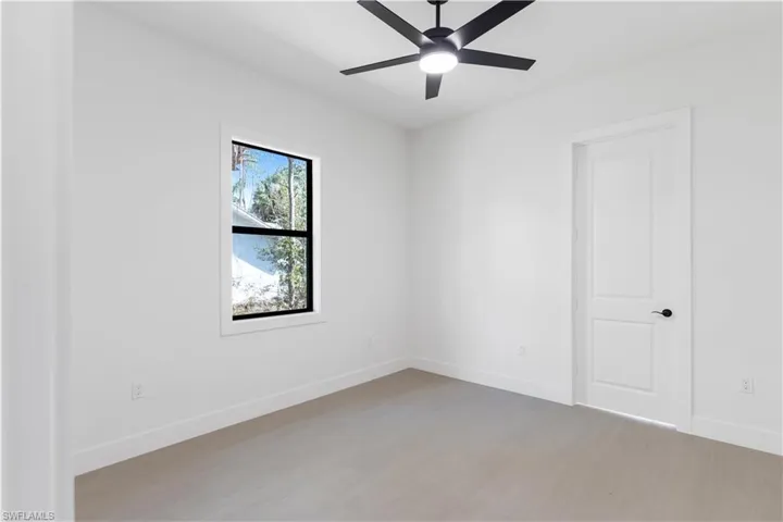 Bedroom with wood-like tile and a ceiling fan