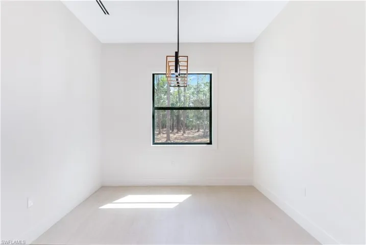 Dining room featuring baseboards and a pedant lighting