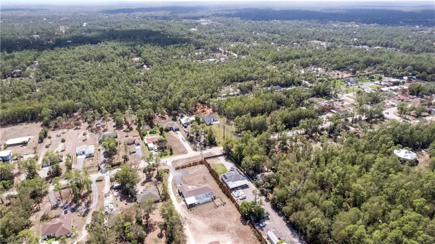 Aerial view of residential area featuring a forest