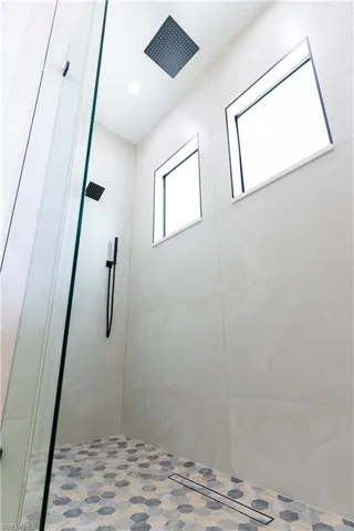 Primary bathroom with a tile shower