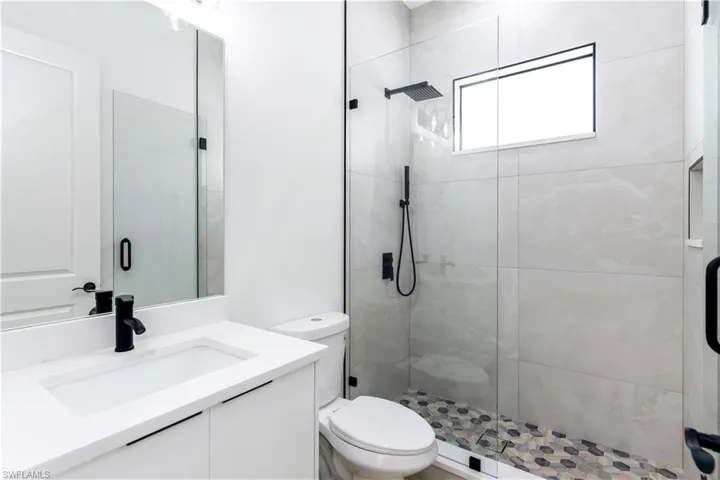 Bathroom with vanity and a stall shower