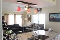 Kitchen with a ceiling fan and open floor plan