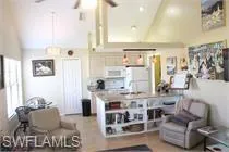 Living area featuring high vaulted ceiling