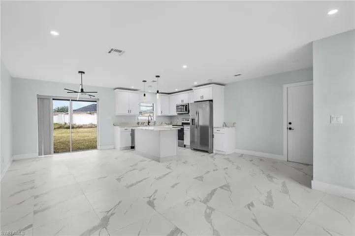 Kitchen with baseboards, light countertops, visible vents, and appliances with stainless steel finishes