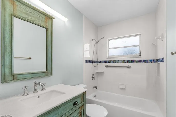 Full bathroom with bathing tub / shower combination, vanity, and toilet