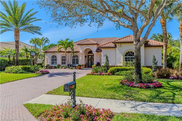 Mediterranean / spanish house with stucco siding, decorative driveway, and a front yard